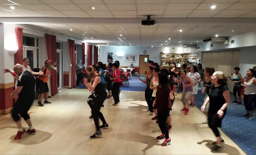 Group of adults over 50 participating in a Zumba class in Ottawa, enjoying low impact dance fitness